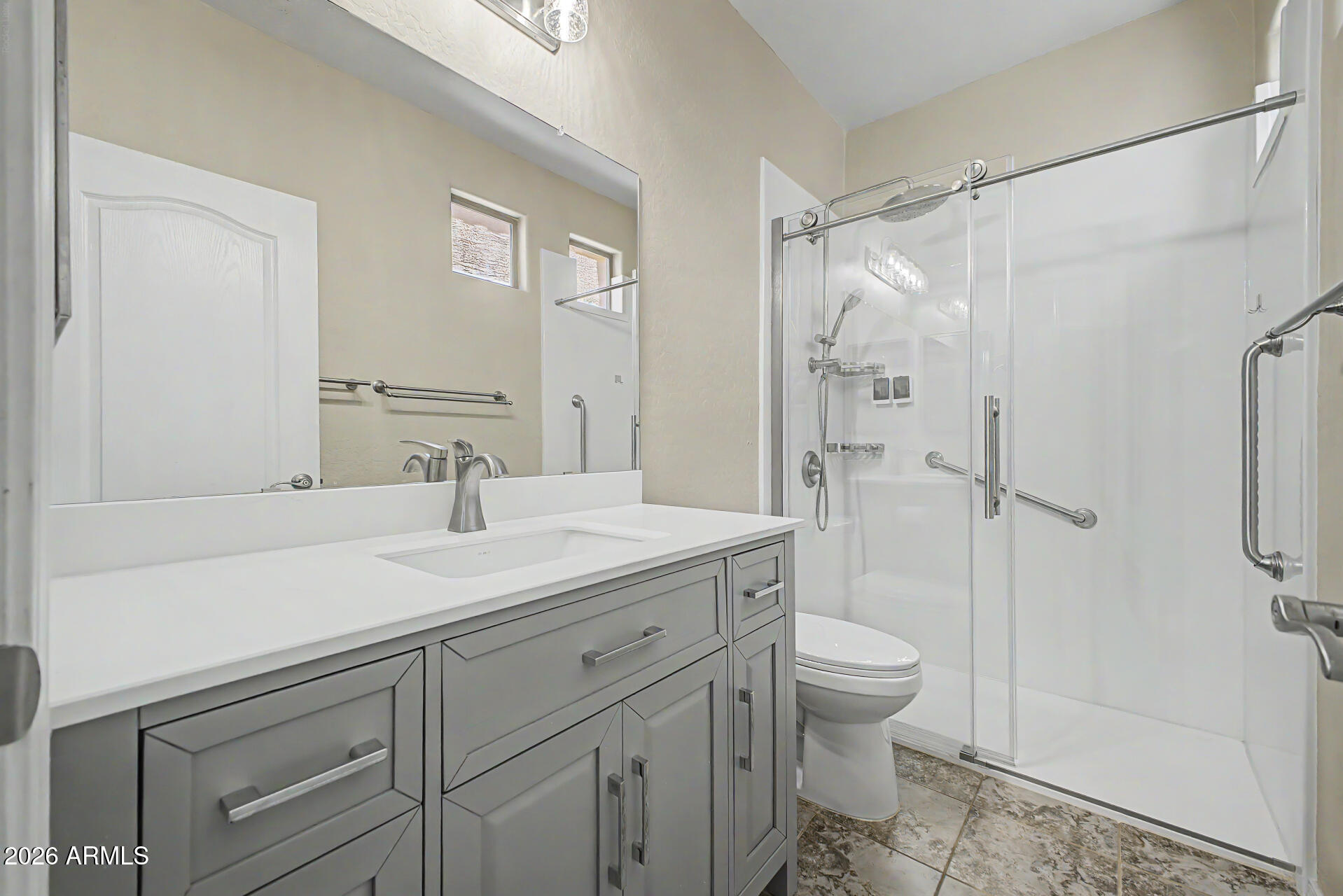 2600 East Springfield Place, Unit 109 Chandler, AZ 85286 - Photo 18 of 38 a bathroom with a sink toilet vanity and shower