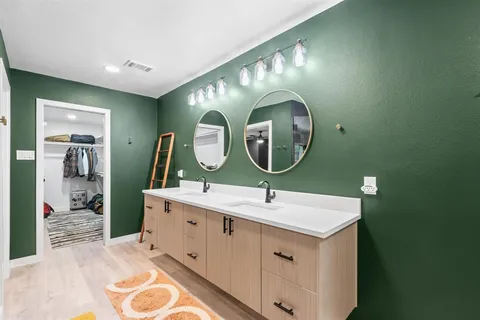 a spacious bathroom with a sink and a mirror