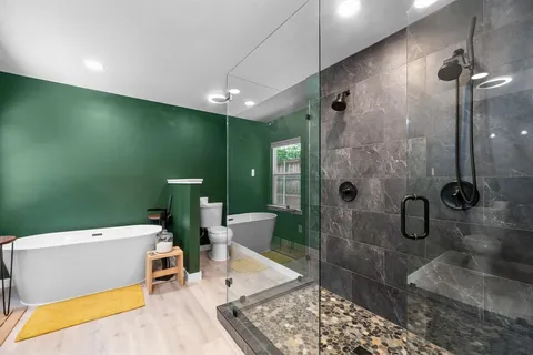 a spacious bathroom with a tub and shower