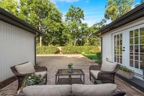 a view of a patio with couple of chairs