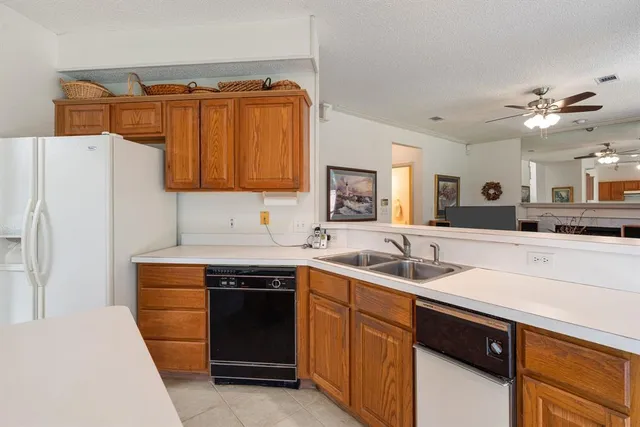 a kitchen with a sink and a refrigerator