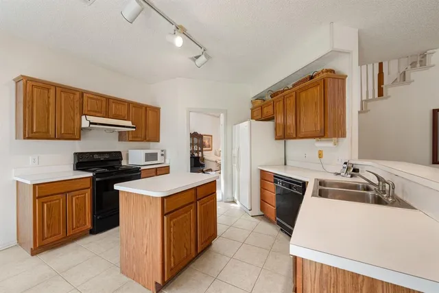 a kitchen with a stove sink and a microwave