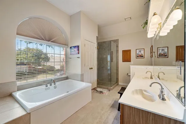 a bathroom with a tub sink and mirror