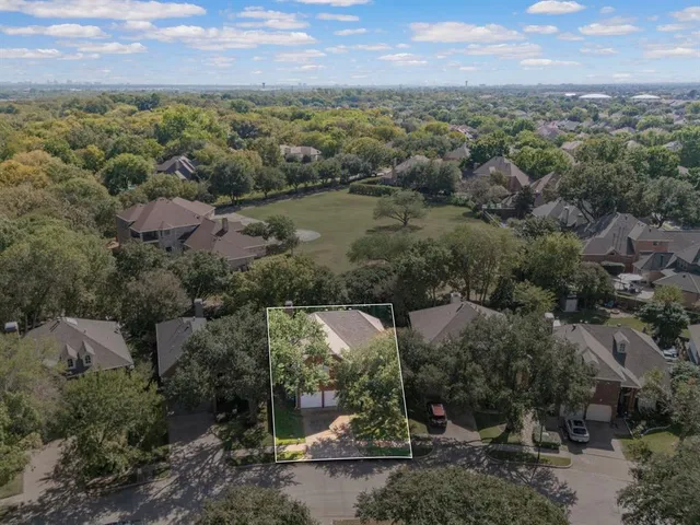 an aerial view of green landscape with trees houses and mountain view