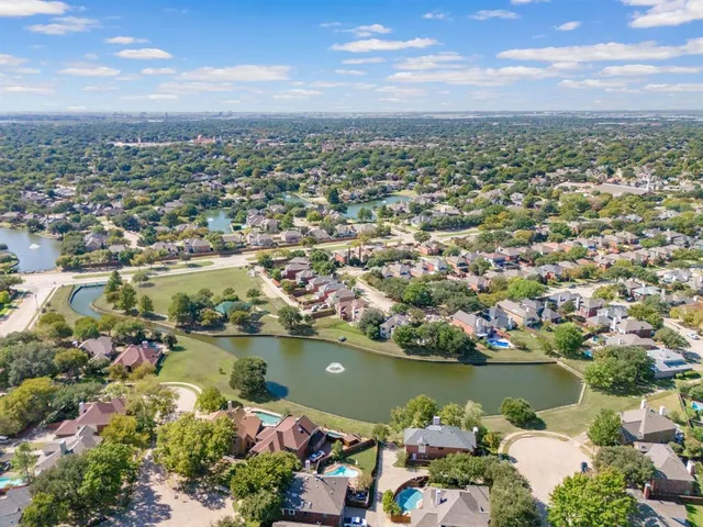 an aerial view of a city with lots of residential buildings lake and ocean view