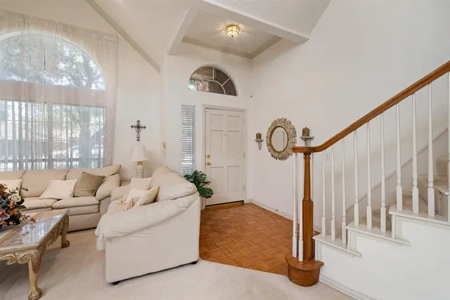 a living room with couches a fireplace with wooden floor