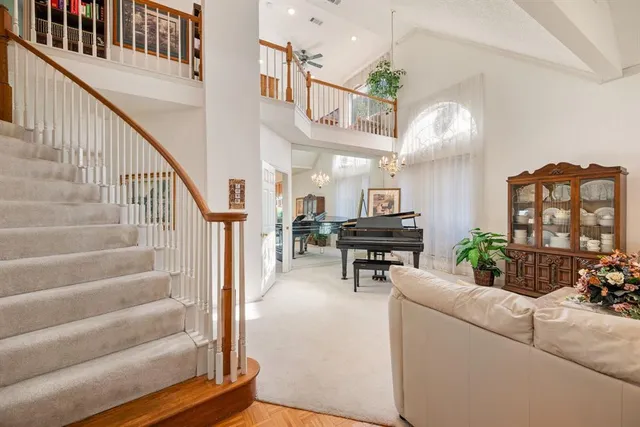 a living room with furniture and a piano