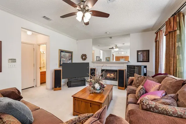 a living room with furniture a fireplace and a flat screen tv