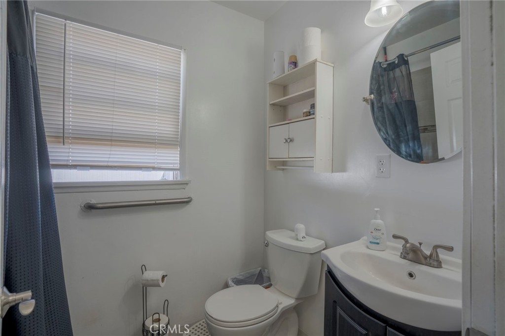 9727 Glandon Street Bellflower, CA 90706 - Photo 13 of 40 a bathroom with a sink a toilet and mirror