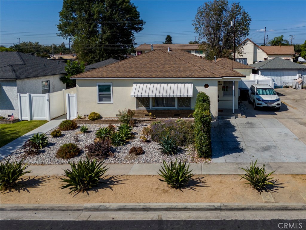 9727 Glandon Street Bellflower, CA 90706 - Photo 2 of 40 a front view of a house with a yard and garage