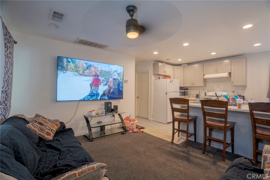 9727 Glandon Street Bellflower, CA 90706 - Photo 21 of 40 a living room with furniture and a flat screen tv