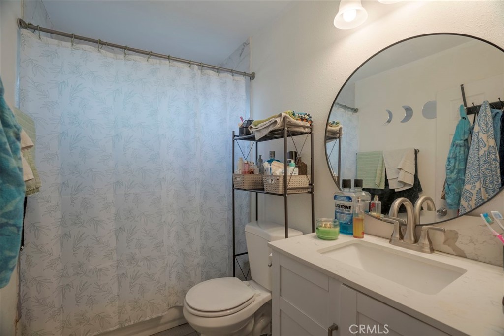 9727 Glandon Street Bellflower, CA 90706 - Photo 23 of 40 a bathroom with a sink a toilet and shower