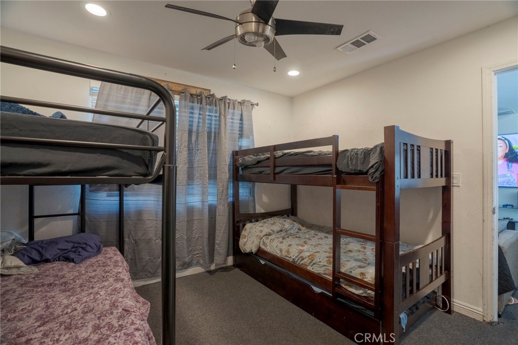 9727 Glandon Street Bellflower, CA 90706 - Photo 25 of 40 a bedroom with a bed and a ceiling fan