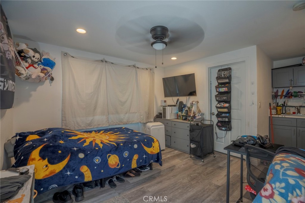 9727 Glandon Street Bellflower, CA 90706 - Photo 31 of 40 a bedroom with furniture and a flat screen tv