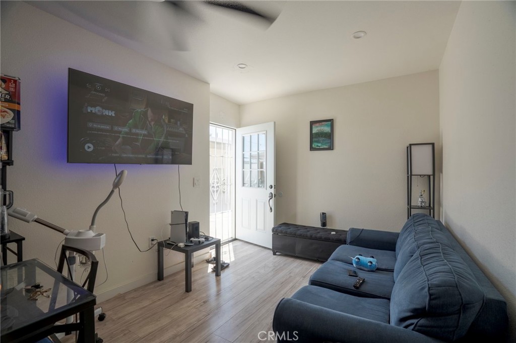 9727 Glandon Street Bellflower, CA 90706 - Photo 34 of 40 a living room with furniture and a flat screen tv