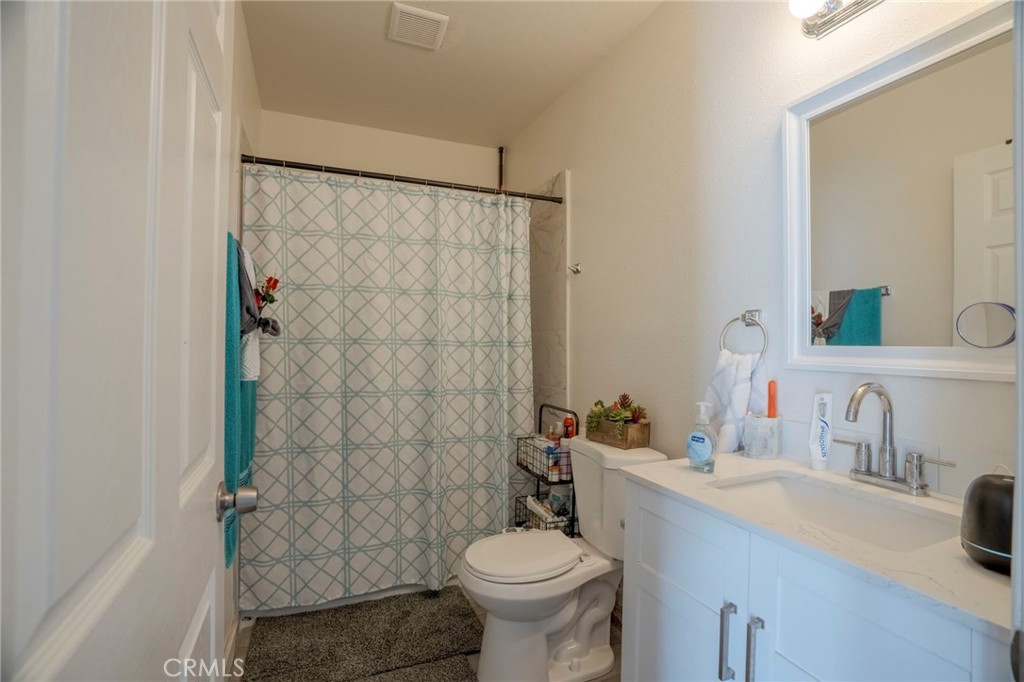 9727 Glandon Street Bellflower, CA 90706 - Photo 37 of 40 a bathroom with a sink toilet and shower