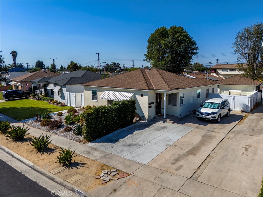 9727 Glandon Street Bellflower, CA 90706 - Photo 5 of 40 a front view of a house with garden space and street view