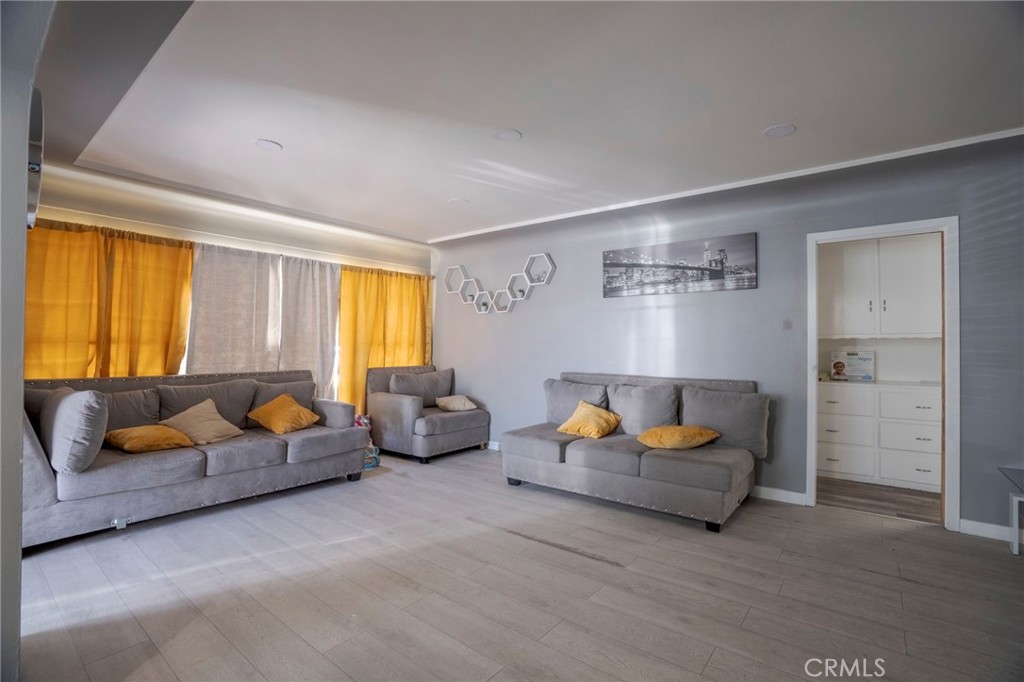 9727 Glandon Street Bellflower, CA 90706 - Photo 7 of 40 a living room with furniture and a couch