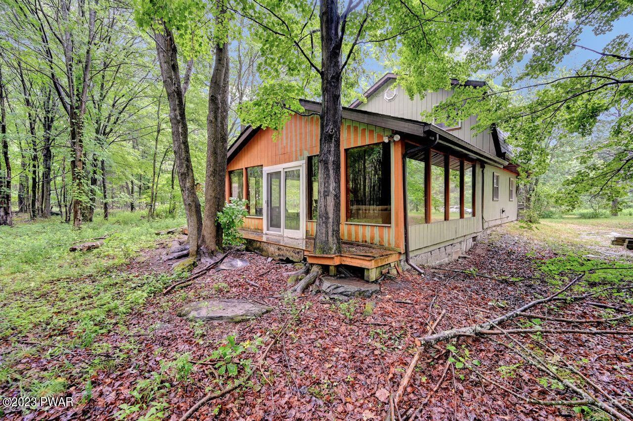 20 Wash Road Waymart, PA 18472 - Photo 3 of 49 a view of a small house with a small yard and large trees