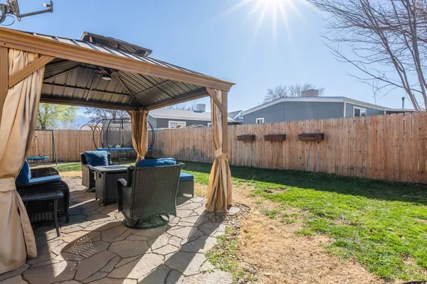 a view of a backyard with sitting area