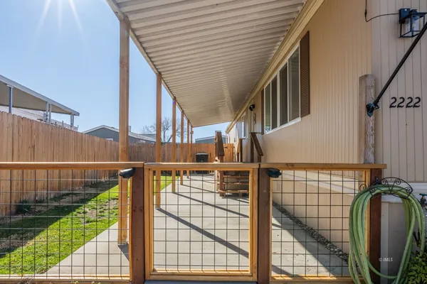 a view of balcony with wooden floor and fence