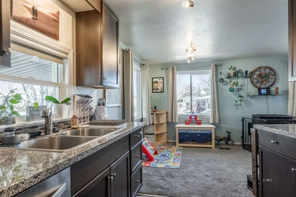 a kitchen with a sink stove and cabinets