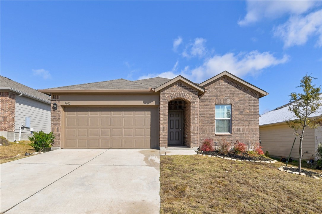 15012 Bullbrier Road Austin, TX 78724 - Photo 1 of 1 a front view of a house with a yard and garage