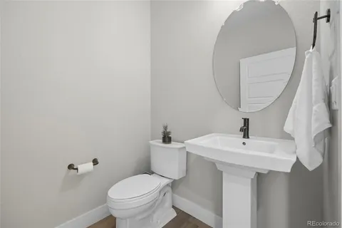 a bathroom with a sink a toilet and a mirror