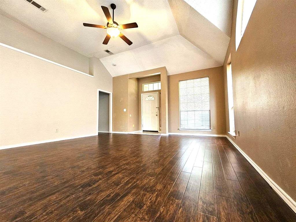 7961 King Arthur Road Frisco, TX 75035 - Photo 11 of 28 a view of an empty room with window and wooden floor