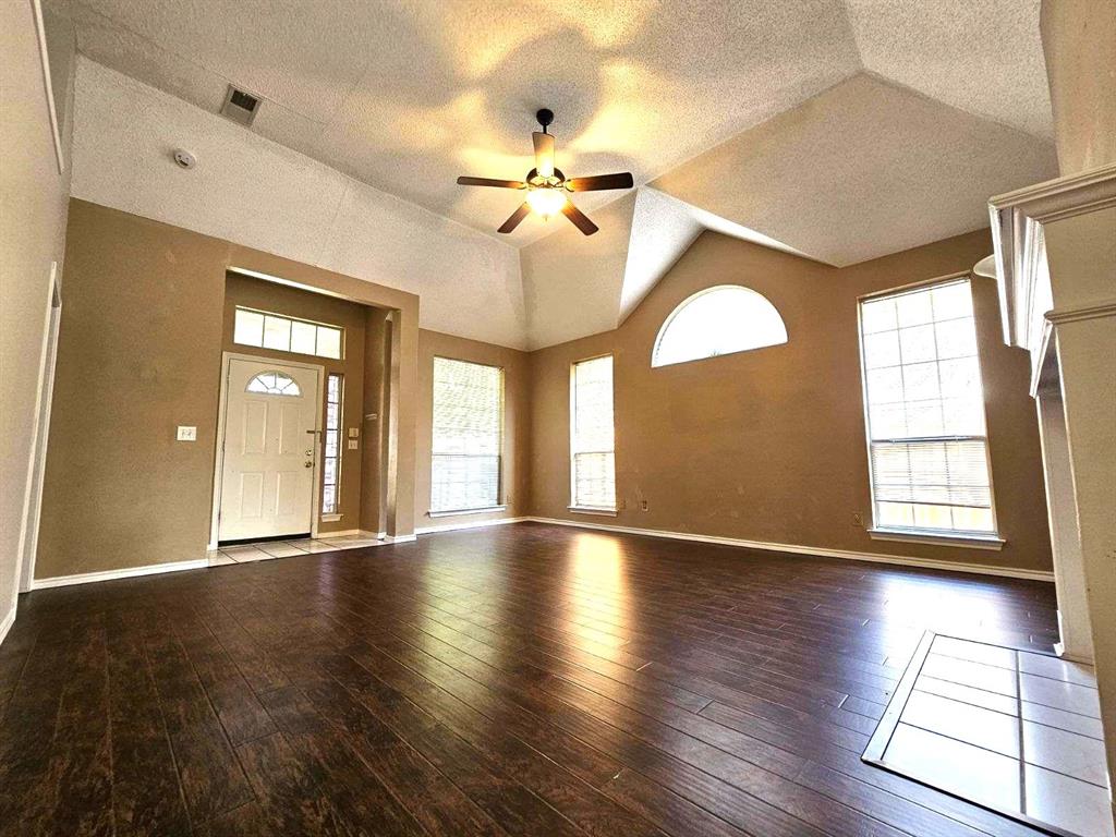 7961 King Arthur Road Frisco, TX 75035 - Photo 12 of 28 a view of an empty room with wooden floor and a window