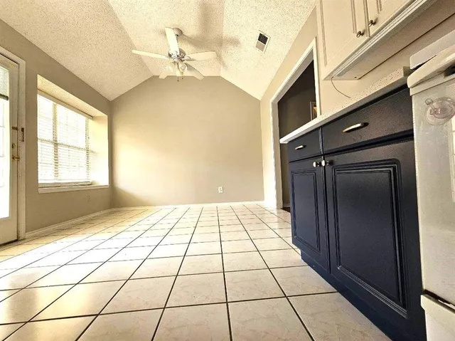 an empty room with wooden floor and a window