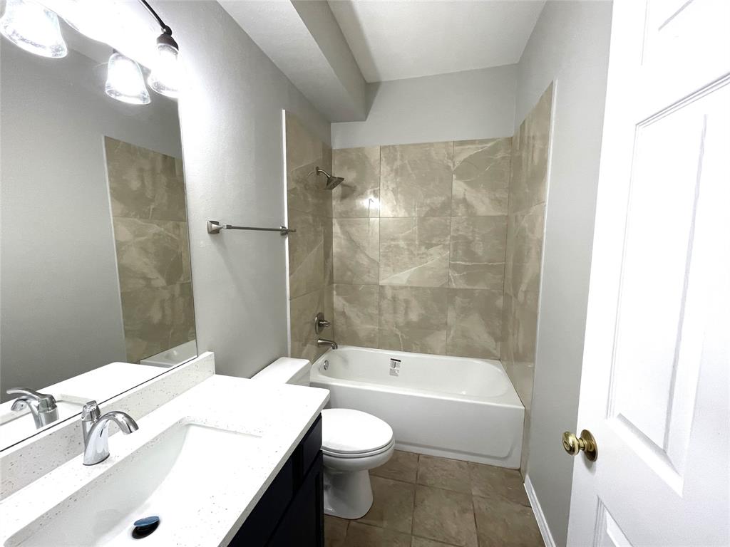 7961 King Arthur Road Frisco, TX 75035 - Photo 18 of 28 a bathroom with a sink a toilet and shower