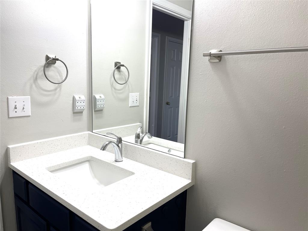 7961 King Arthur Road Frisco, TX 75035 - Photo 19 of 28 a bathroom with a sink vanity and a mirror