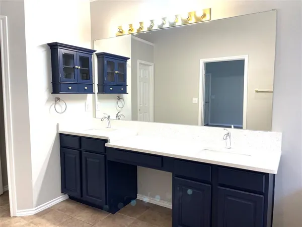 an empty room with wooden floor closet and windows