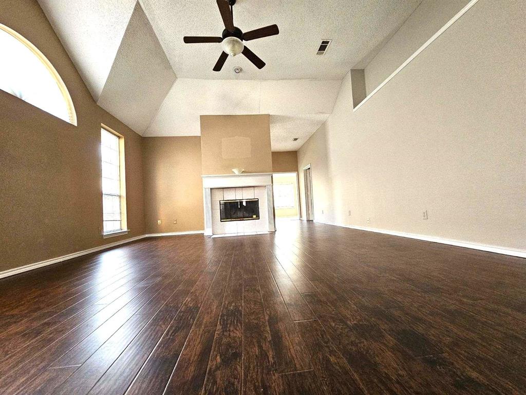 7961 King Arthur Road Frisco, TX 75035 - Photo 5 of 28 a view of empty room with wooden floor and fireplace