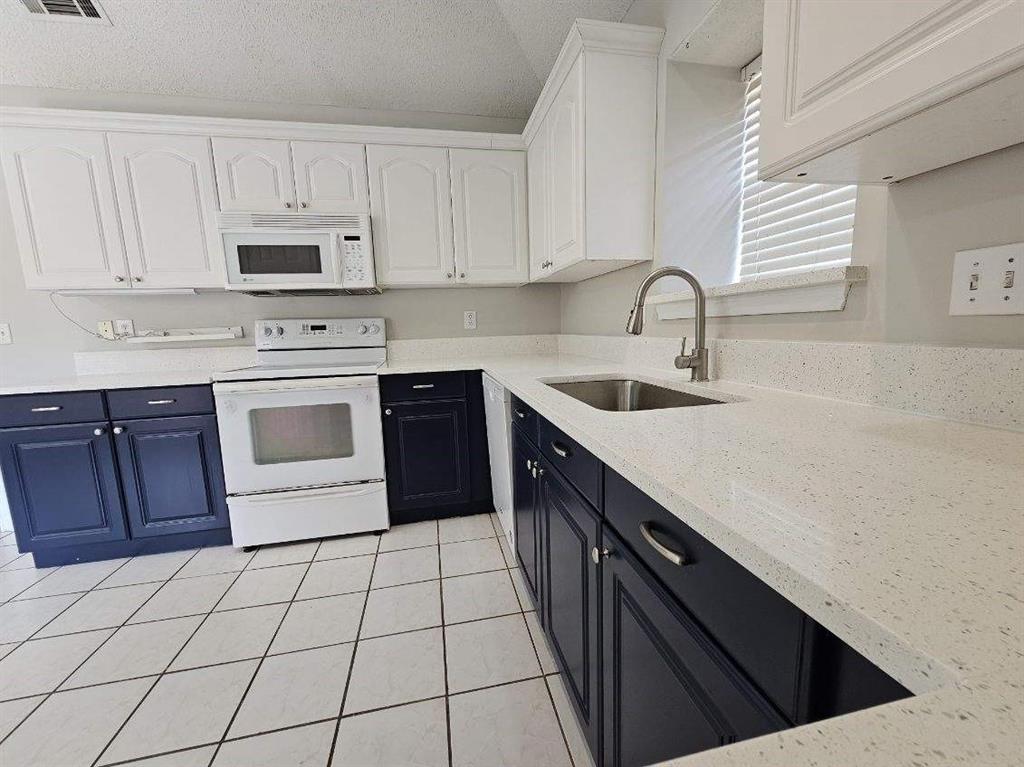 7961 King Arthur Road Frisco, TX 75035 - Photo 8 of 28 a kitchen with stainless steel appliances granite countertop a sink stove and cabinets