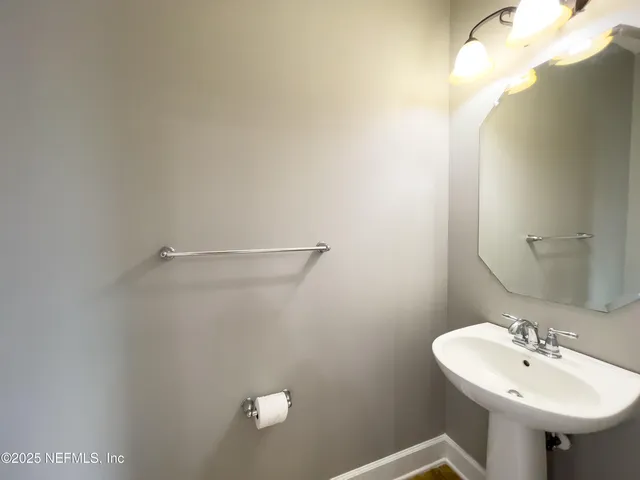 a bathroom with a sink a mirror and a toilet