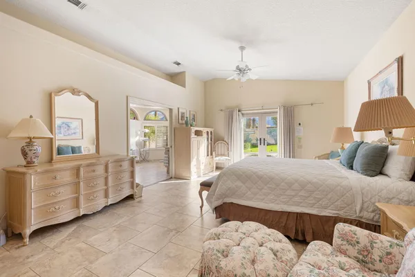 a bedroom with a large bed and a dresser