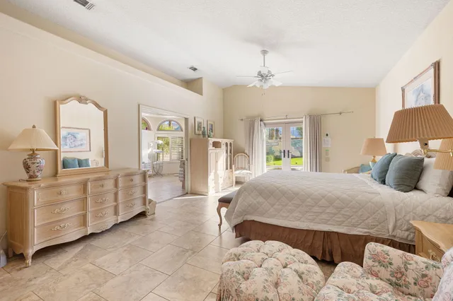 a bedroom with a large bed and a dresser