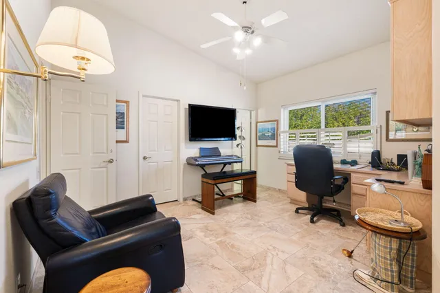 a livingroom with workspace couch and a window