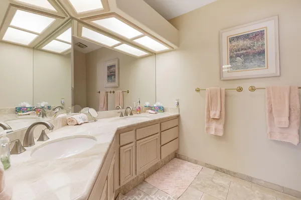a bathroom with a double vanity sink mirror and