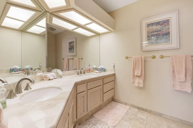 a bathroom with a double vanity sink mirror and