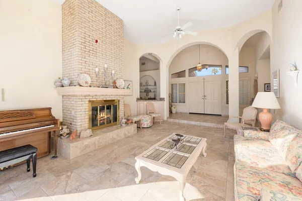 a living room with furniture and a fireplace