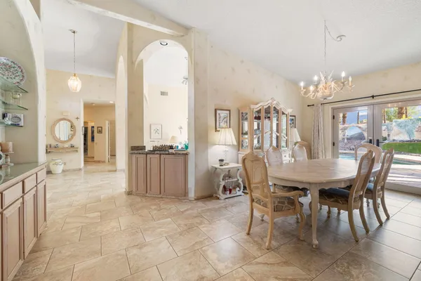a view of a dining room with furniture and chandelier
