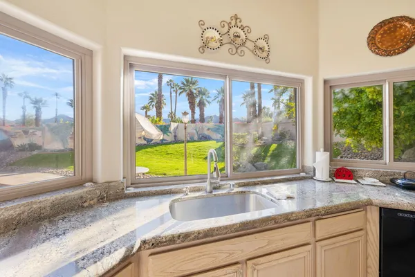a kitchen with a sink and a large window