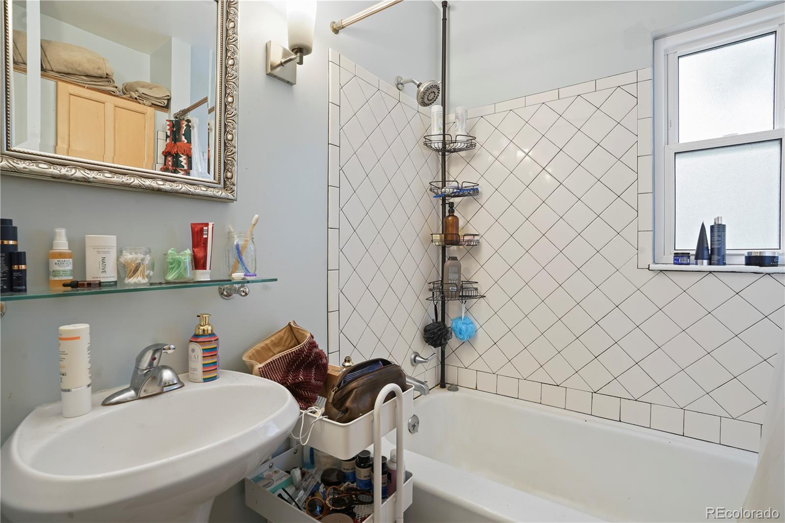 2690 Ash Street Denver, CO 80207 - Photo 6 of 20 a bathroom with a sink and a bathtub