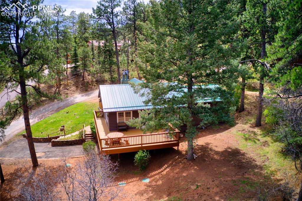 9455 Mohawk Trail Cascade, CO 80809 - Photo 30 of 33 This shows a little bit better of how the lot runs, notice there is a brand new septic system installed right heregrass will pop up soon and it will be beautiful in this easy to care for yard.