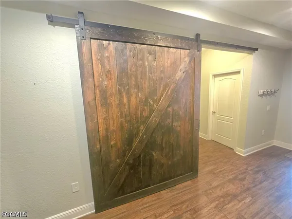 a view of a bathroom with wooden floor and a shower
