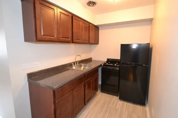 a kitchen with a sink and cabinets
