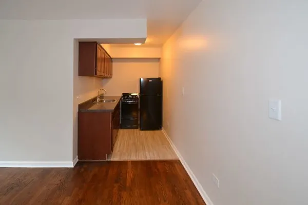 a view of a kitchen from a hallway